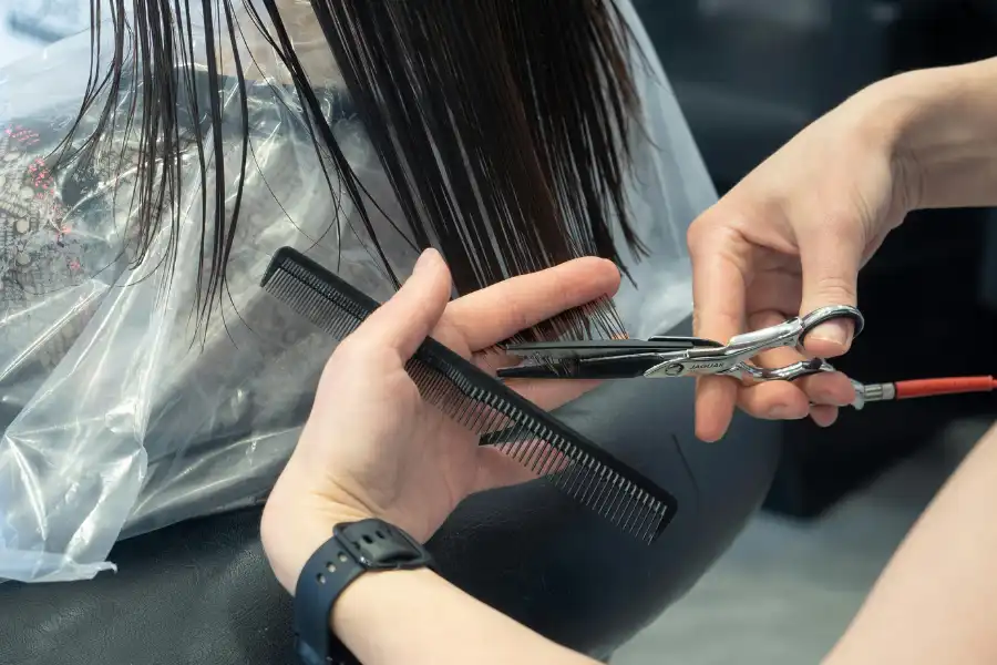 A woman getting her hair cut in a salon in Iloilo