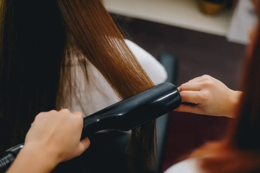 A woman having her hair rebonded